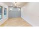 Elegant dining room with hardwood floors, statement lighting, accent wall, and natural light from windows at 3774 Eli Dr, Snellville, GA 30039