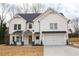 Beautiful two-story white brick home with a covered porch and a two-car garage on a large lot at 3774 Eli Dr, Snellville, GA 30039