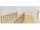Hallway with wooden floors, white walls, and black iron railing and spindles at 3774 Eli Dr, Snellville, GA 30039