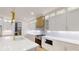 Modern kitchen featuring white cabinets, quartz countertops, stainless steel appliances, and gold hardware accents at 3774 Eli Dr, Snellville, GA 30039