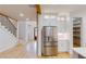 Modern kitchen featuring stainless steel appliances, custom cabinets, and easy access to the pantry at 3774 Eli Dr, Snellville, GA 30039