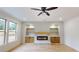 Comfortable living room featuring a fireplace, built-in shelving, large windows offering abundant natural light at 3774 Eli Dr, Snellville, GA 30039