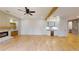 Open-concept living area with fireplace, built-ins, hardwood floors, wet bar, and wine cooler, perfect for entertaining at 3774 Eli Dr, Snellville, GA 30039
