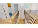 Upper-level view of the staircase with wood treads and black metal railings, showcasing open design and natural light at 3774 Eli Dr, Snellville, GA 30039