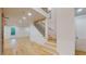Bright foyer featuring a modern staircase with wood treads and black metal railings plus an exposed brick accent wall at 3774 Eli Dr, Snellville, GA 30039
