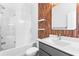 Modern bathroom features a shower over tub, unique wood accent wall, and floating shelves at 4462 Dandelion Ln, Atlanta, GA 30342