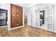 Open bedroom layout with sliding door to the Primary bath, access to a walk-in closet and wood-look floors at 4462 Dandelion Ln, Atlanta, GA 30342