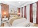 Stylish bedroom with a wood accent wall, elegant curtains, and ample natural light at 4462 Dandelion Ln, Atlanta, GA 30342