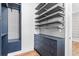 Organized walk-in closet with open shelving and dresser for convenient storage at 4462 Dandelion Ln, Atlanta, GA 30342