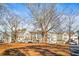 Exterior view of a residential neighborhood with multi-story homes and mature trees at 4462 Dandelion Ln, Atlanta, GA 30342