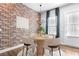 Charming dining room showcasing a round table, stylish chairs, and a decorative exposed brick wall at 4462 Dandelion Ln, Atlanta, GA 30342