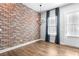 Dining room features an exposed brick wall, modern lighting, and wood floors at 4462 Dandelion Ln, Atlanta, GA 30342