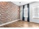 The dining area boasts a brick accent wall, hardwood floors, and a modern chandelier for an inviting atmosphere at 4462 Dandelion Ln, Atlanta, GA 30342