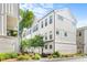 Bright and modern white townhome exterior with well-maintained landscaping at 4462 Dandelion Ln, Atlanta, GA 30342