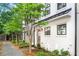 View of townhomes featuring white siding and beautifully landscaped front yards and gravel walkway at 4462 Dandelion Ln, Atlanta, GA 30342