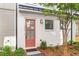 Inviting townhome featuring peach-colored front door, black trim, and freshly landscaped yard at 4462 Dandelion Ln, Atlanta, GA 30342