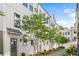 Stunning exterior view of white-painted townhomes with black trim and landscaped walking path at 4462 Dandelion Ln, Atlanta, GA 30342