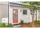 Inviting front entrance with salmon colored door, small bushes, and mulch landscaping at 4462 Dandelion Ln, Atlanta, GA 30342