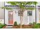 Charming white brick home with a vibrant salmon-colored front door, complemented by a well-manicured yard at 4462 Dandelion Ln, Atlanta, GA 30342
