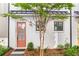 Charming home entrance with a salmon-colored door and beautifully landscaped front yard at 4462 Dandelion Ln, Atlanta, GA 30342