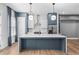 Modern kitchen with a large center island, stainless steel appliances, and pendant lighting at 4462 Dandelion Ln, Atlanta, GA 30342