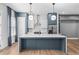 Modern kitchen with a large blue island, white cabinets, and stainless steel appliances at 4462 Dandelion Ln, Atlanta, GA 30342