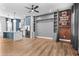 Open-concept living room and kitchen with hardwood floors and custom built-in shelving units at 4462 Dandelion Ln, Atlanta, GA 30342