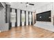 Large living space featuring hardwood floors, media center, and ample natural light from many windows at 4462 Dandelion Ln, Atlanta, GA 30342