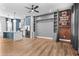Open living space with hardwood floors and custom built-ins and kitchen in the background at 4462 Dandelion Ln, Atlanta, GA 30342