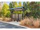 Community mailboxes with protective shelter and lush landscaping in a residential area at 4462 Dandelion Ln, Atlanta, GA 30342