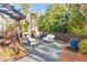 Charming outdoor patio featuring comfortable seating, a pergola, and a stone fireplace at 4462 Dandelion Ln, Atlanta, GA 30342