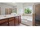 Bathroom featuring double vanity, tub and separate shower at 4630 Roseman Trl, Cumming, GA 30040