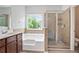 Bathroom featuring double vanity, tub and separate shower with glass door at 4630 Roseman Trl, Cumming, GA 30040