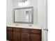 Bathroom boasts a double sink vanity with dark wood cabinets, large mirror and modern lighting at 4630 Roseman Trl, Cumming, GA 30040