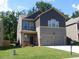 Inviting two-story home with a well-manicured lawn and a convenient two-car garage at 4630 Roseman Trl, Cumming, GA 30040