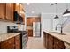Well-equipped kitchen featuring granite countertops, stainless appliances, and dark-wood cabinetry at 4630 Roseman Trl, Cumming, GA 30040