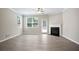 Bright living area with a ceiling fan, fireplace, and a door that leads to the backyard at 4630 Roseman Trl, Cumming, GA 30040