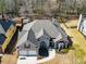 An aerial view highlights a two-story home with a well-manicured lawn, two-car garage, and mature landscaping at 492 Thorn Creek Way, Dallas, GA 30157