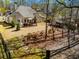 An aerial perspective reveals a home with a gazebo, storage shed, and mature trees at 492 Thorn Creek Way, Dallas, GA 30157