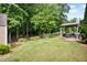 Expansive backyard with lush green lawn, wooded views, and a stylish covered patio at 492 Thorn Creek Way, Dallas, GA 30157