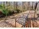 Enjoy the nature views from this bench near the creek in the wooded backyard at 492 Thorn Creek Way, Dallas, GA 30157