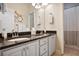 Bright bathroom featuring a double sink vanity with granite counters and a decorative bicycle art piece at 492 Thorn Creek Way, Dallas, GA 30157