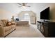 Comfortable carpeted bedroom with vaulted ceilings, large TV, and a cozy sitting area at 492 Thorn Creek Way, Dallas, GA 30157