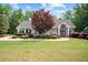 Community clubhouse with manicured lawn, flower beds, and covered veranda at 492 Thorn Creek Way, Dallas, GA 30157