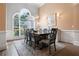 Charming dining area with a large arched window and wood floors, providing a bright and inviting space at 492 Thorn Creek Way, Dallas, GA 30157