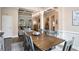 Elegant dining room with a large table and chairs, featuring coffered ceilings that offer a seamless transition to the living room at 492 Thorn Creek Way, Dallas, GA 30157