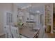Elegant dining area with modern chandelier, adjacent kitchen, and view into the bright living room at 492 Thorn Creek Way, Dallas, GA 30157
