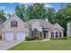 Charming white brick home with a two-car garage, landscaped front yard, and inviting curb appeal at 492 Thorn Creek Way, Dallas, GA 30157