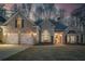 Charming brick home featuring a two-car garage, manicured lawn, and inviting entryway at 492 Thorn Creek Way, Dallas, GA 30157