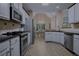 Well-equipped kitchen with stainless steel appliances, white cabinets, and a view into the dining area at 492 Thorn Creek Way, Dallas, GA 30157